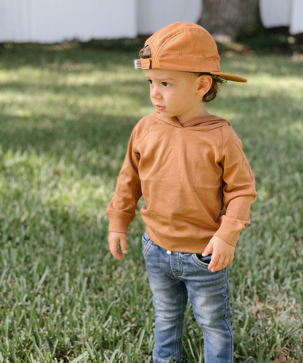Roman modeling the Our Madison Pullover is a super-soft wardrobe must-have! This lightweight pullover hoodie is great for cozy layering and is easy to mix and match and is 100% organic cotton. 