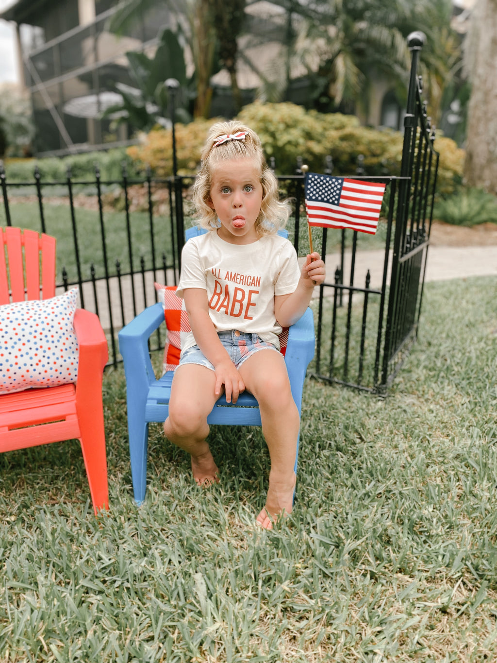 A girl sitting in her Roman Pierre All American babe T-shirt  