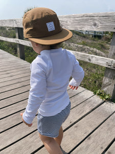 Waterproof Clay Five-Panel Hat on toddler walking on the boardwalk 